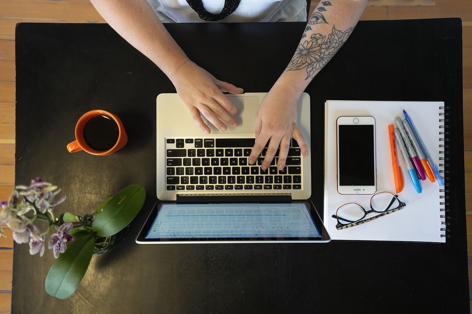 Top-down view of a person working on a laptop