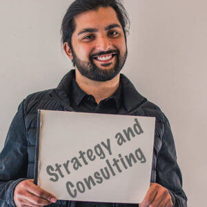 Marketeering Group team member holding a sketch that reads "Strategy and Consultation"