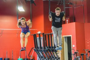 Man and woman on gymnastic rings doing dibs