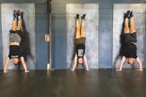 NW Crossfit class students doing a handstand against a wall