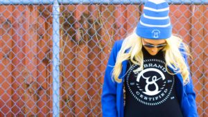 Woman wearing Oy brand shirt and beanie