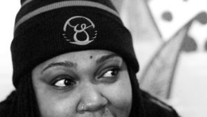 Upclose of a woman wearing an Oy brand beanie
