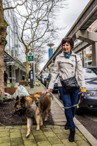 Woman walking her dog in the streets of downtown Seattle