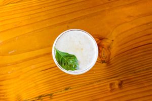 Top down view of an alcoholic beverage offered at Shingletown with a mint leaf on top