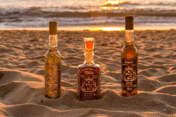 Baston de Rey tequila bottles on sandy beach