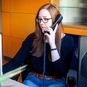 Woman sitting at desk on the phone