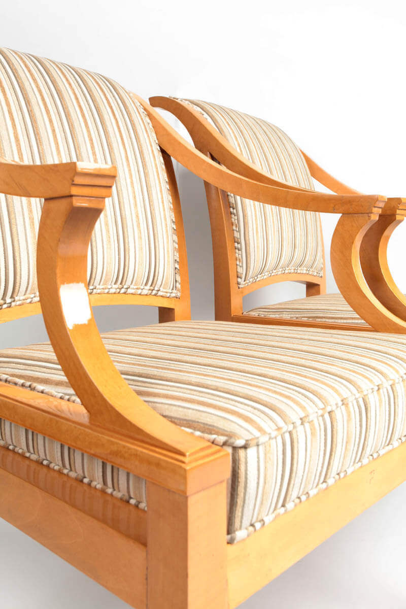 Wood-framed chairs with striped cushioning