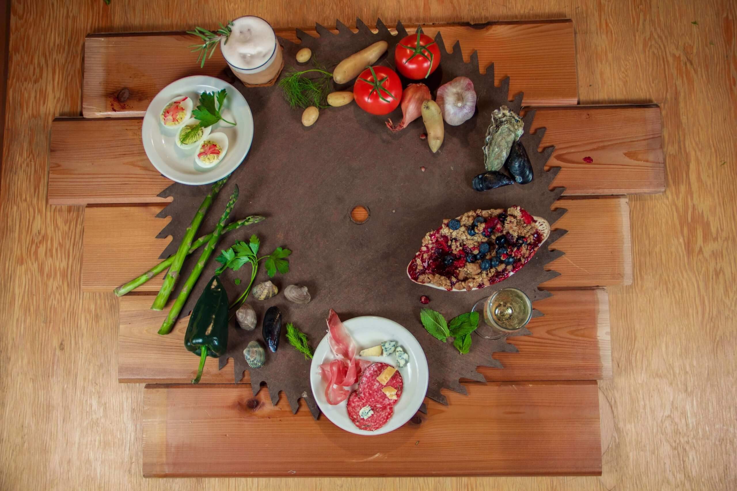 Top down view of Shingletown's food and vegetables on a large saw