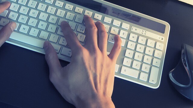 Person typing on a keyboard